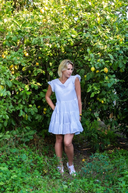 Girl in the garden with oranges fruit