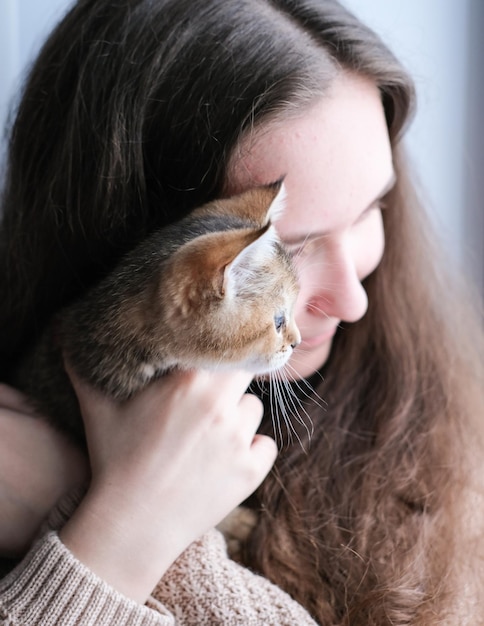 The girl gently hugs a cute kitten Warm relationship between humans and animals