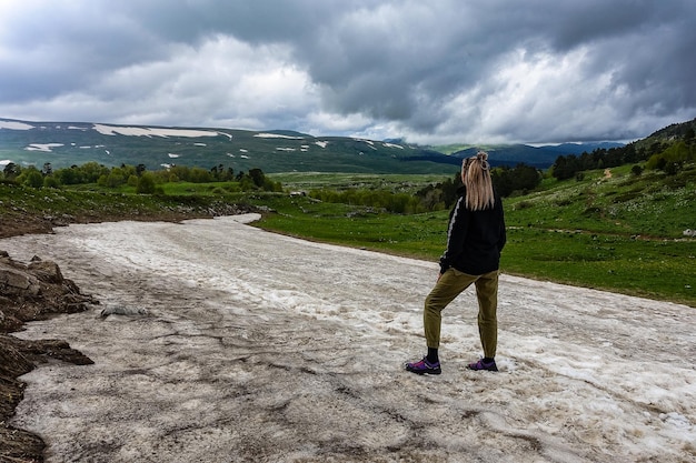 A girl on a glacier on the LagoNaki plateau Snow in Adygea Russia 2021