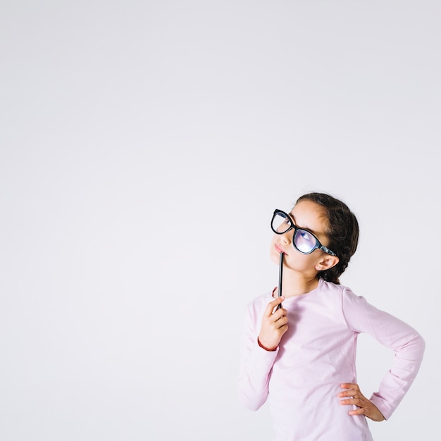 Girl in glasses thinking and looking up