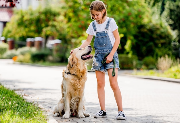 Girl and golden retriever dog