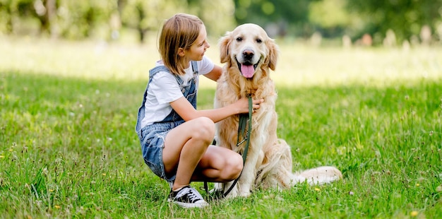 Girl and golden retriever dog