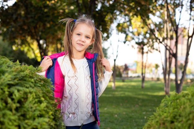 Girl among green bushes