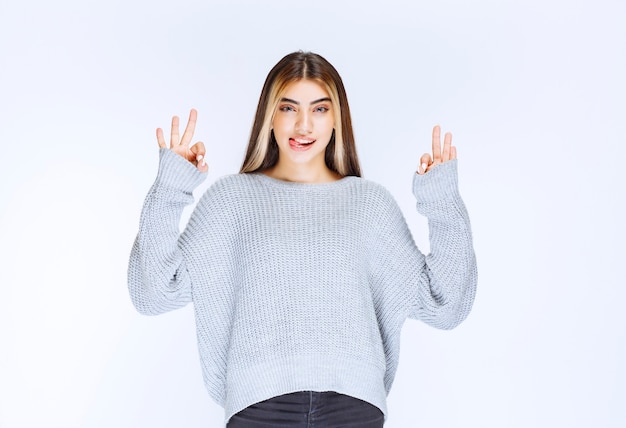 Girl in grey shirt feeling peaceful and happy.