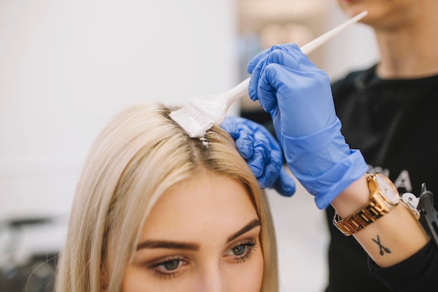 Girl in hairdresser parlor having coloring procedure