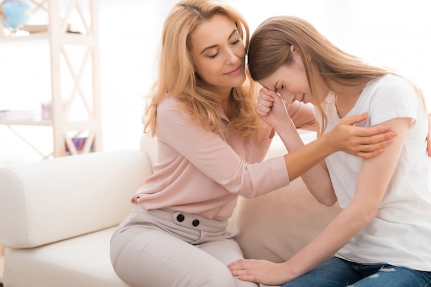 The girl has a problem. Mom hugs the girl.