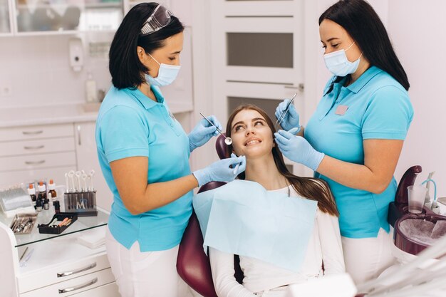 The girl has a visit to the dentist for a dental examination