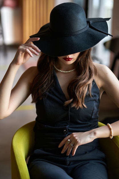 Girl and a hat, Elegant Woman Beauty in Wide Broad Brim Hat covered face