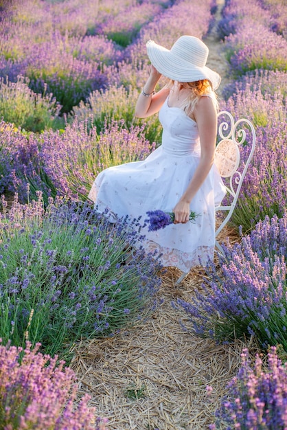 Girl in a hat on a lavender field at sunrise Harmony with nature