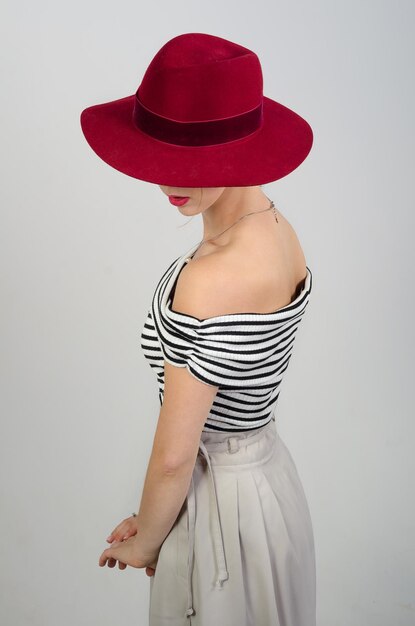 Girl in a hat on a white background