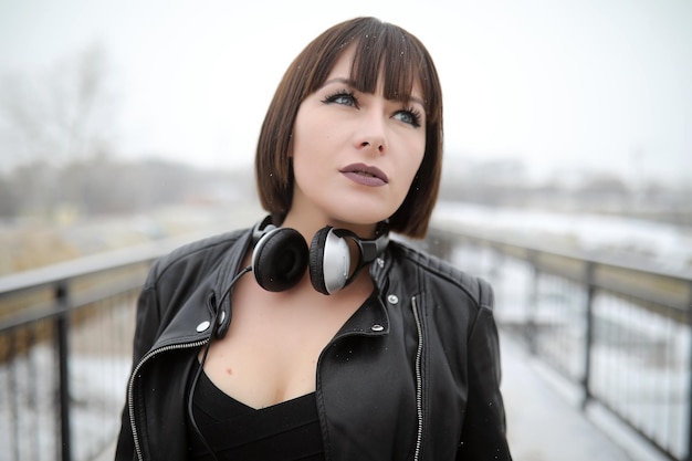 Girl in headphones listening to music outdoors