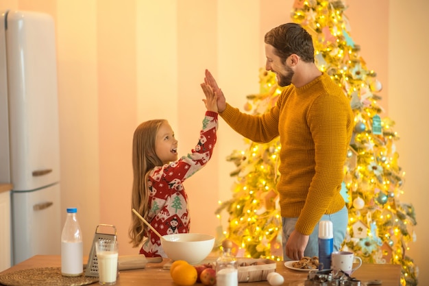 Girl and her dad feeling good and doing high five