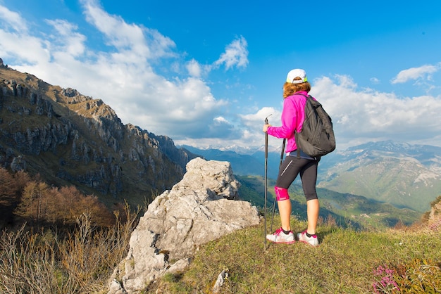 Girl hiker rests in the mountains