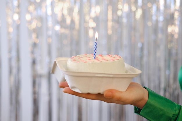 Girl Hold Bento Cake Decorated By red hearts against the background of silver tinsel Cakes For One Person One Candle In the middle of cake