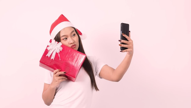 Girl hold gift box make selfie or video online with xmas christmas prop accessories