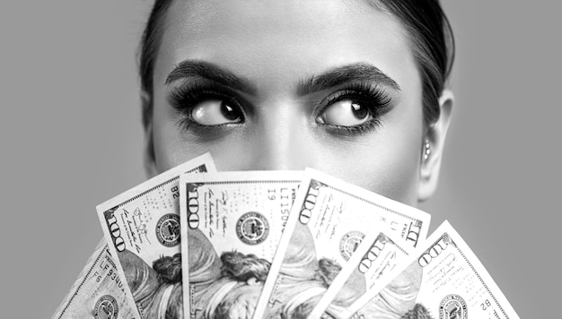 Girl holding cash money in dollar banknotes Woman holding lots of money in dollar currency Luxury beauty and money concept Black and white