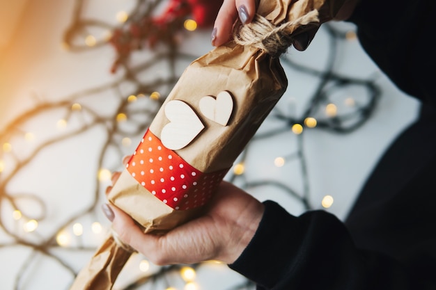 girl holding a Christmas gift in hand