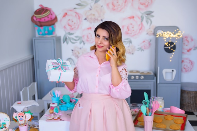 Girl holding a gift box and talking on the phone