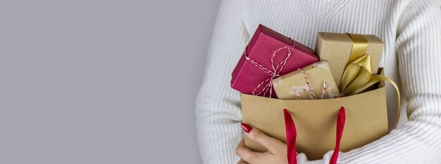 Girl holding New Year's gifts in her hands.