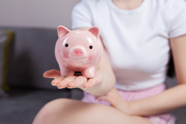 Girl holding a piggy bank