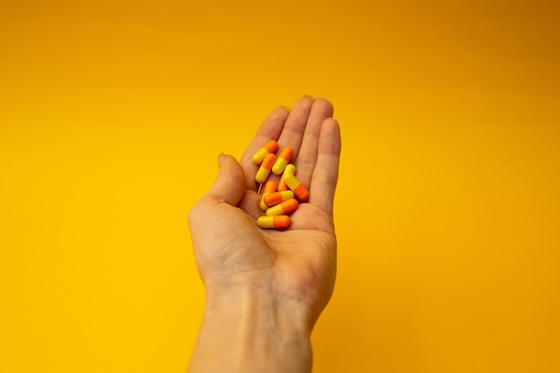 A girl holding a pill in her hand