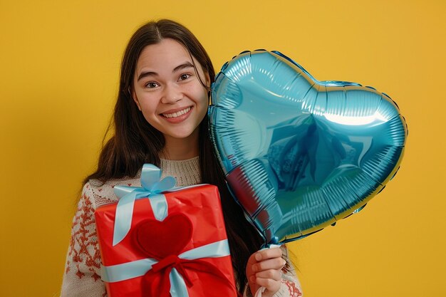 Photo a girl holding a red gift with a heart on it