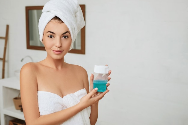 Girl holding skincare product