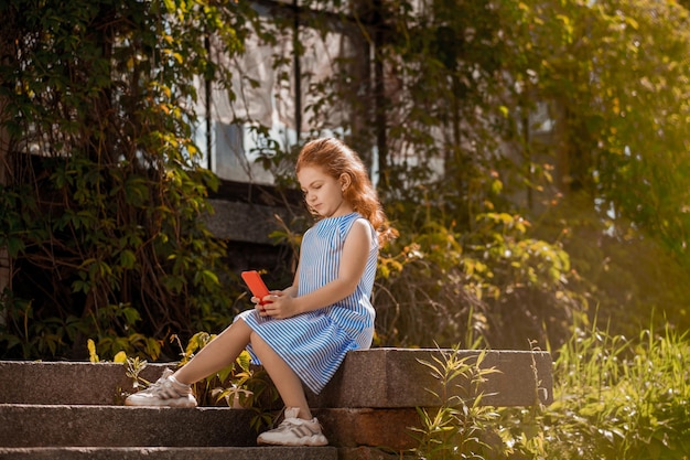 A girl holding a smartphone in hands