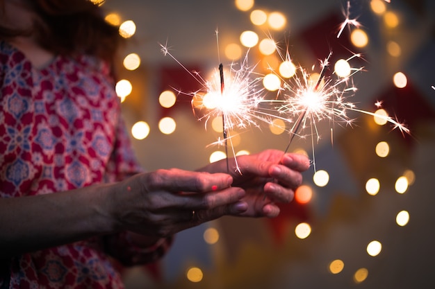 Girl holds bengal lights - happy christmas and merry holidays