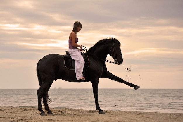 Girl and  horse on the beach