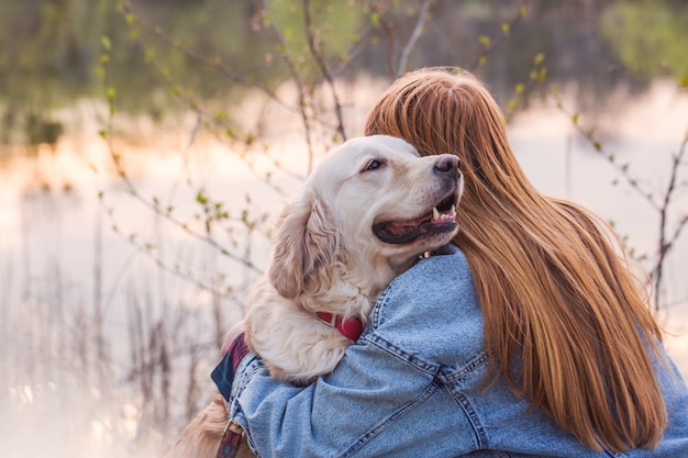 girl hugging her dog