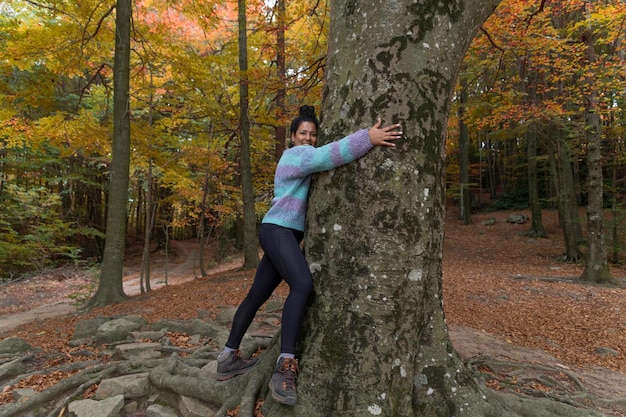 Girl hugs a big tree