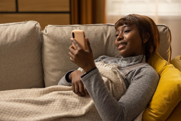 The girl is browsing social media which allows to get away from reality