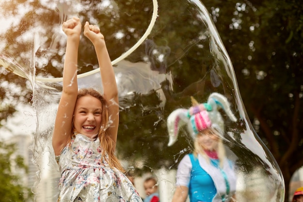 Girl is doing a soap show. Original genre. Large soap bubbles