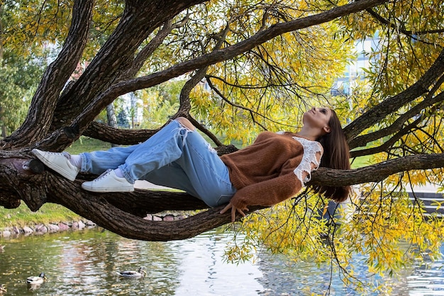 A girl is dotting on a tree branch