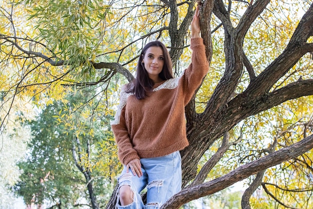 A girl is dotting on a tree branch