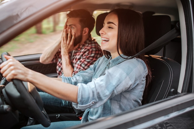 Girl is driving car and laughing