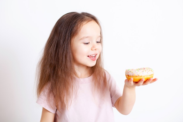 The girl is going to bite off the doughnut Tasty and sweet Harmful food