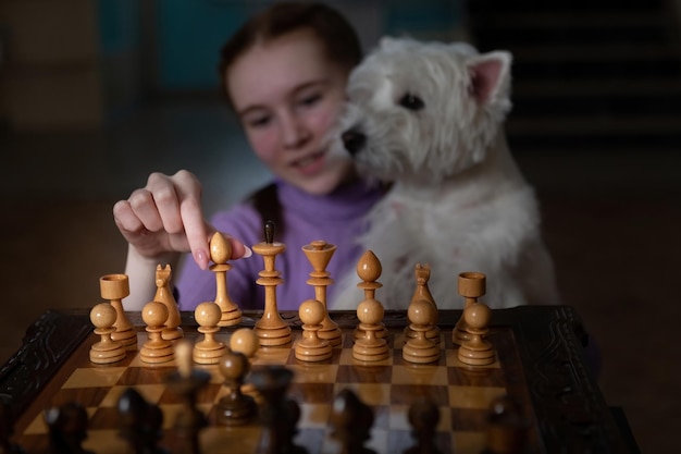 A girl is playing chess