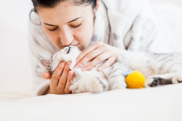 The girl is playing with a cat