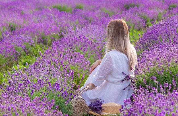 The girl is resting in the lavender field