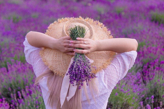 The girl is resting in the lavender field