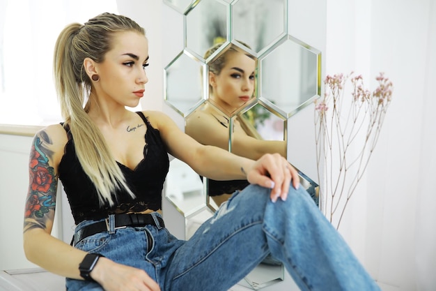 The girl is resting in the loft Young stylish girl posing in the bathroom