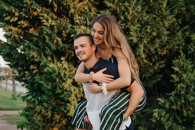 A girl is riding her boyfriend in the evening in Spain