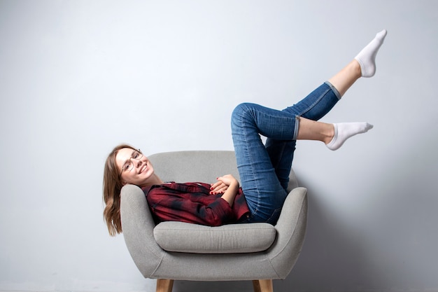 girl is sitting on a soft comfortable chair