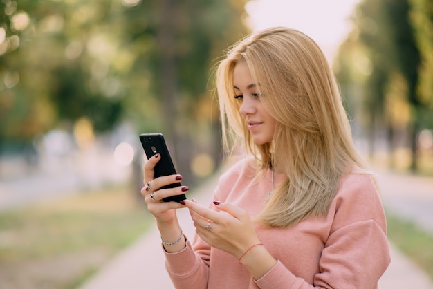 Girl is using smartphone on street