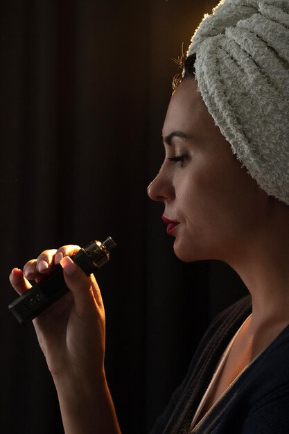 A girl is vaping a vaper releases smoke from her mouth electronic cigarettes and a girl closeup