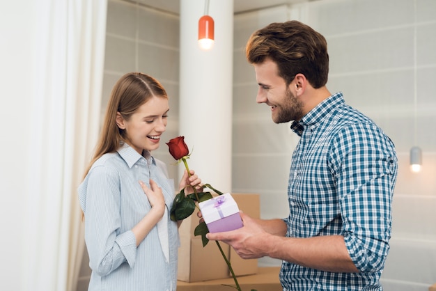 Girl is very happy with the gifts from the guy.