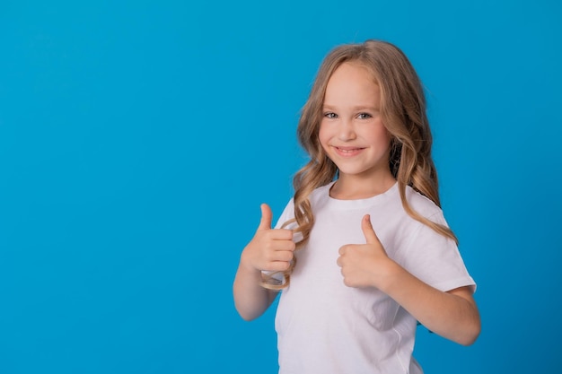 girl in jeans and a white T-shirt points her finger at something, a place for text