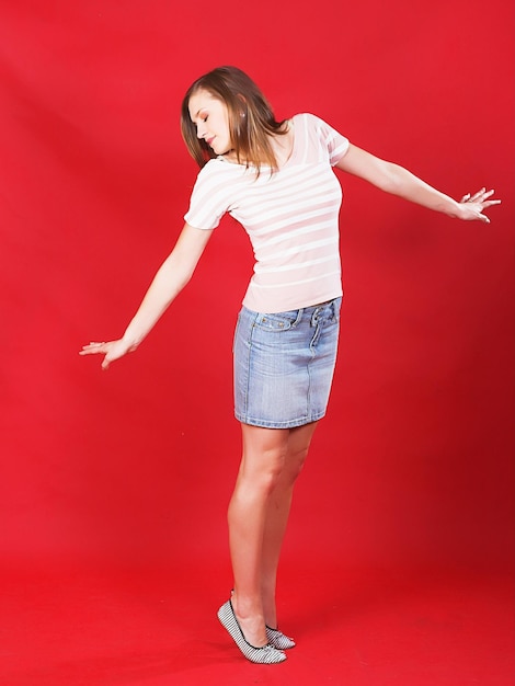 Girl jumping of joy over red